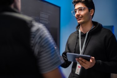 Closeup software developers discussing programming i Stock